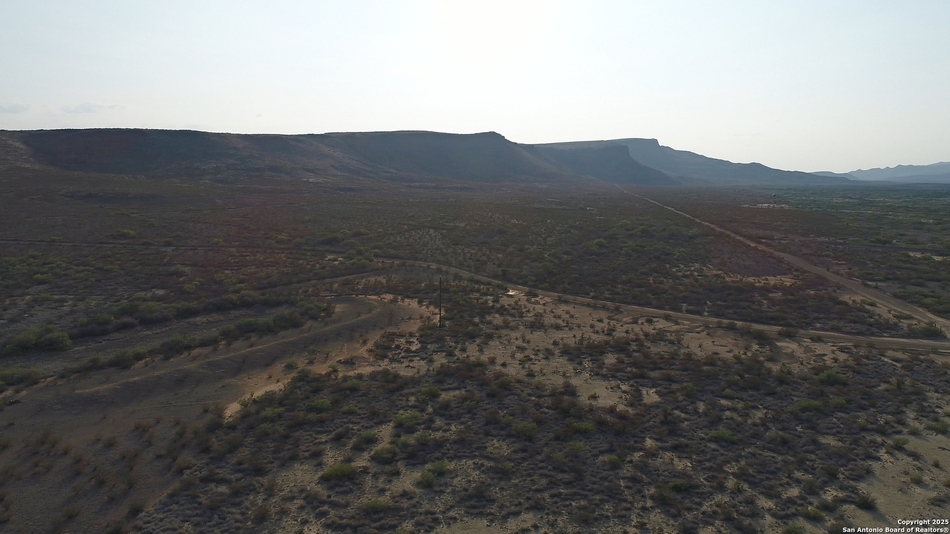0 Ivy Road Alpine, TX 79830 - Photo 5 of 50 a view of a dry yard with mountains in the background