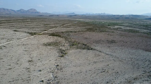 a view of an ocean beach and mountain