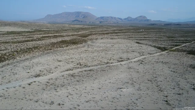 a view of an ocean beach and mountain