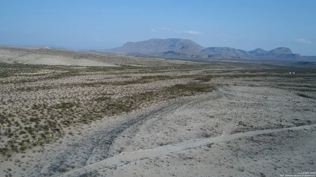 a view of an ocean beach and mountain