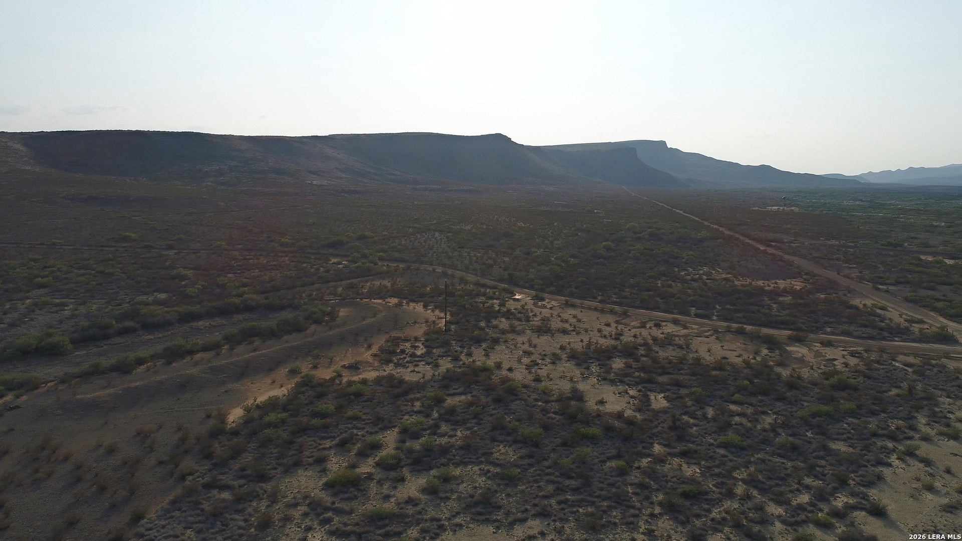 0 Ivy Road Alpine, TX 79830 - Photo 9 of 50 a view of a dry yard with mountains in the background