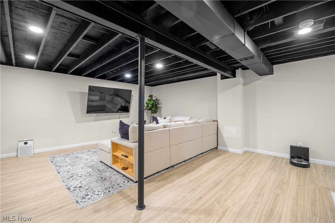 2161 Fowl Road Elyria, OH 44035 - Photo 31 of 46 Finished lower level featuring a black painted exposed ceiling, recessed lighting, light wood-finish flooring, and light-toned walls
