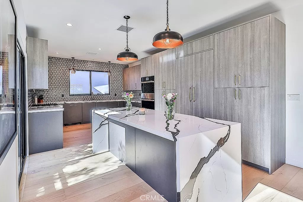 19532 Bermuda Street Porter Ranch, CA 91326 - Photo 12 of 74 a kitchen with stainless steel appliances granite countertop a sink a stove and a refrigerator