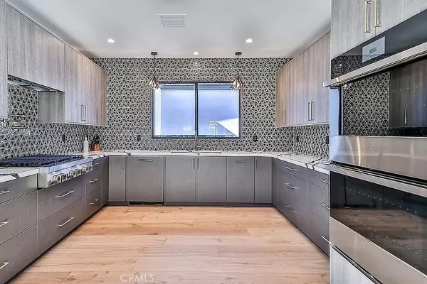 a living room with furniture large window and a chandelier
