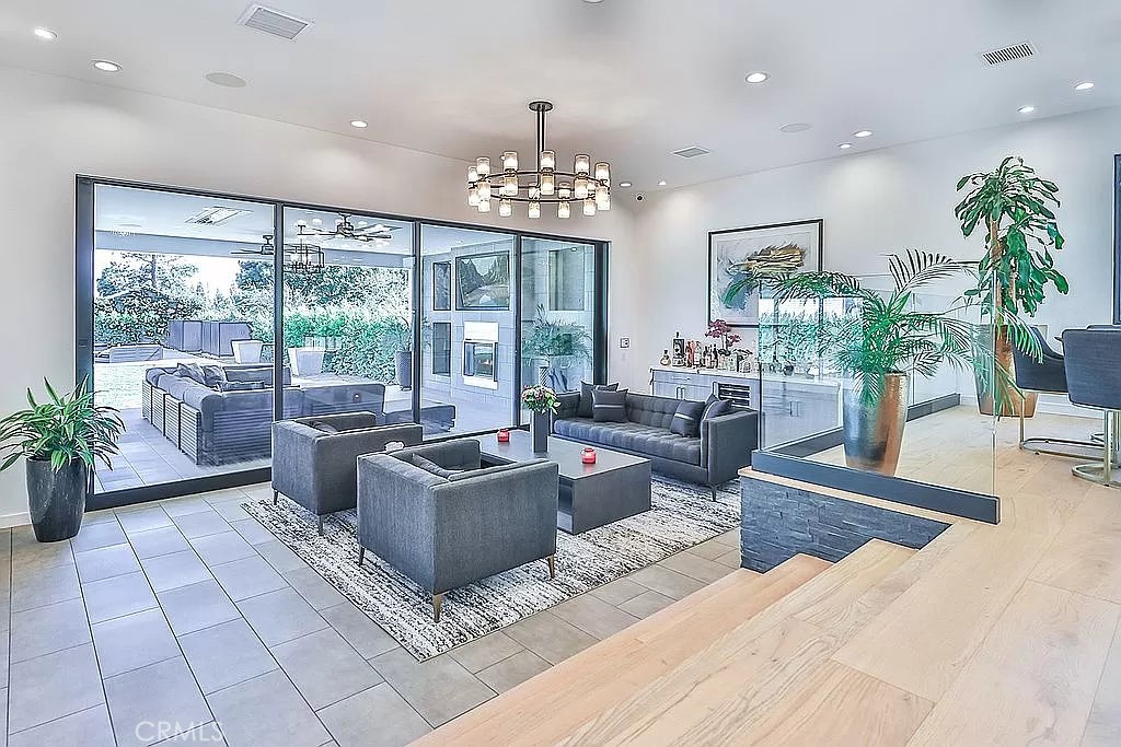 19532 Bermuda Street Porter Ranch, CA 91326 - Photo 20 of 74 a living room with furniture large window and a chandelier