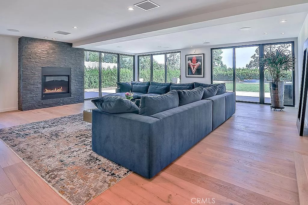 19532 Bermuda Street Porter Ranch, CA 91326 - Photo 22 of 74 a living room with furniture and a fireplace