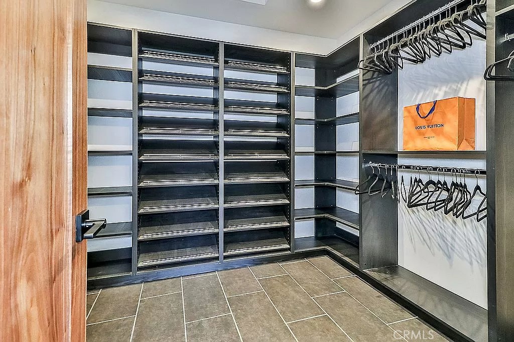 19532 Bermuda Street Porter Ranch, CA 91326 - Photo 31 of 74 a view of walk in closet with empty racks