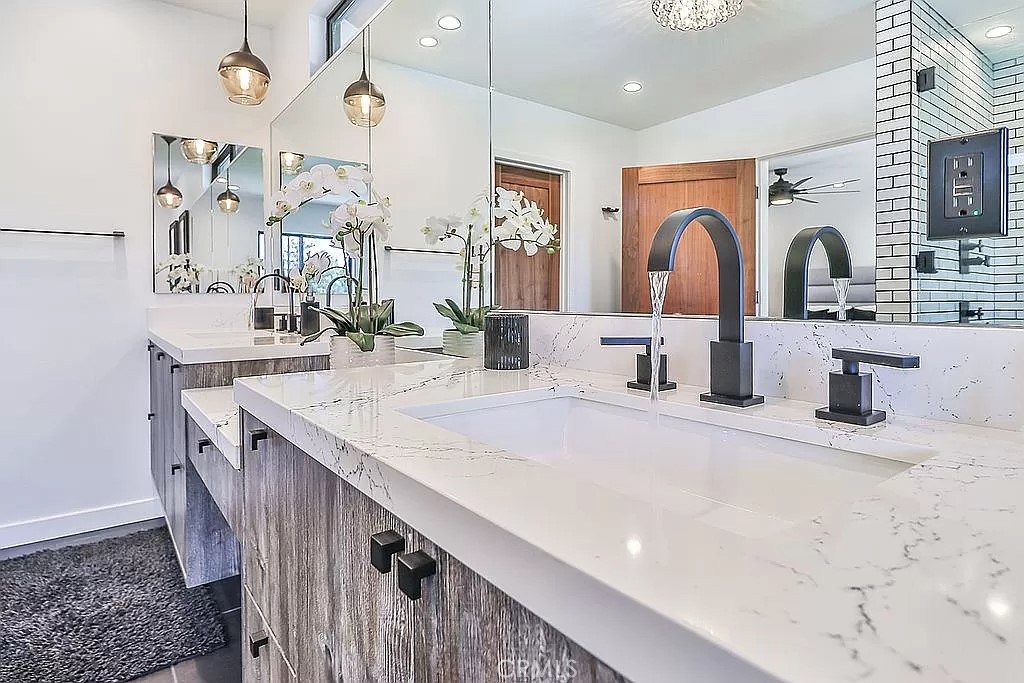 19532 Bermuda Street Porter Ranch, CA 91326 - Photo 33 of 74 a kitchen with stainless steel appliances kitchen island granite countertop a sink and cabinets
