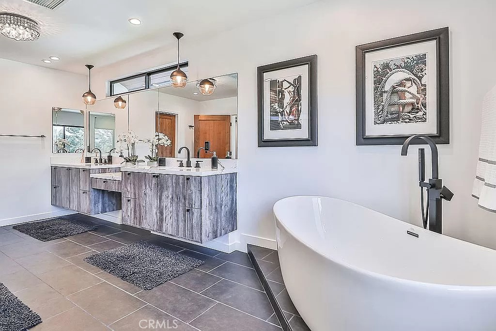 19532 Bermuda Street Porter Ranch, CA 91326 - Photo 36 of 74 a bathroom with a bathtub a sink and a mirror