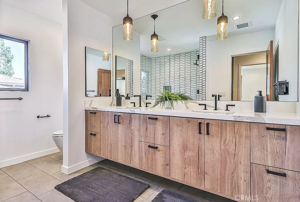 19532 Bermuda Street Porter Ranch, CA 91326 - Photo 40 of 74 a bathroom with double sink and a mirror