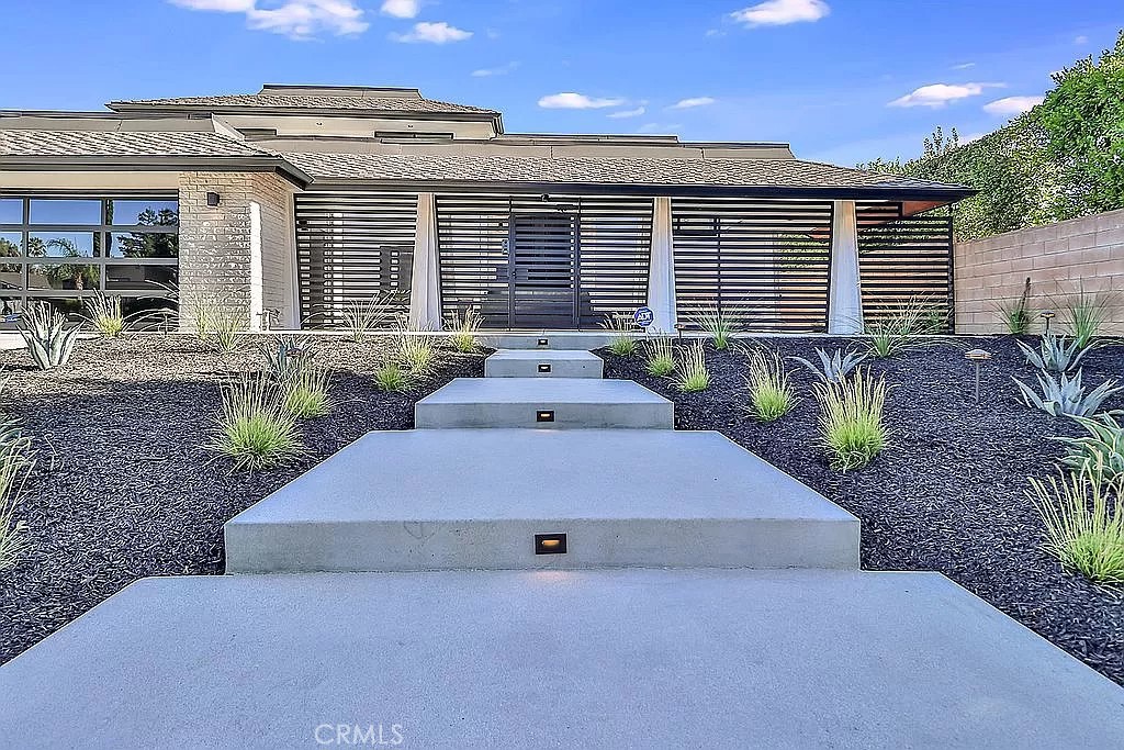 19532 Bermuda Street Porter Ranch, CA 91326 - Photo 4 of 74 a front view of a house with garden