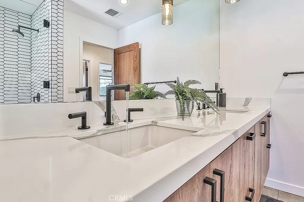 19532 Bermuda Street Porter Ranch, CA 91326 - Photo 41 of 74 a bathroom with a double vanity sink and a mirror