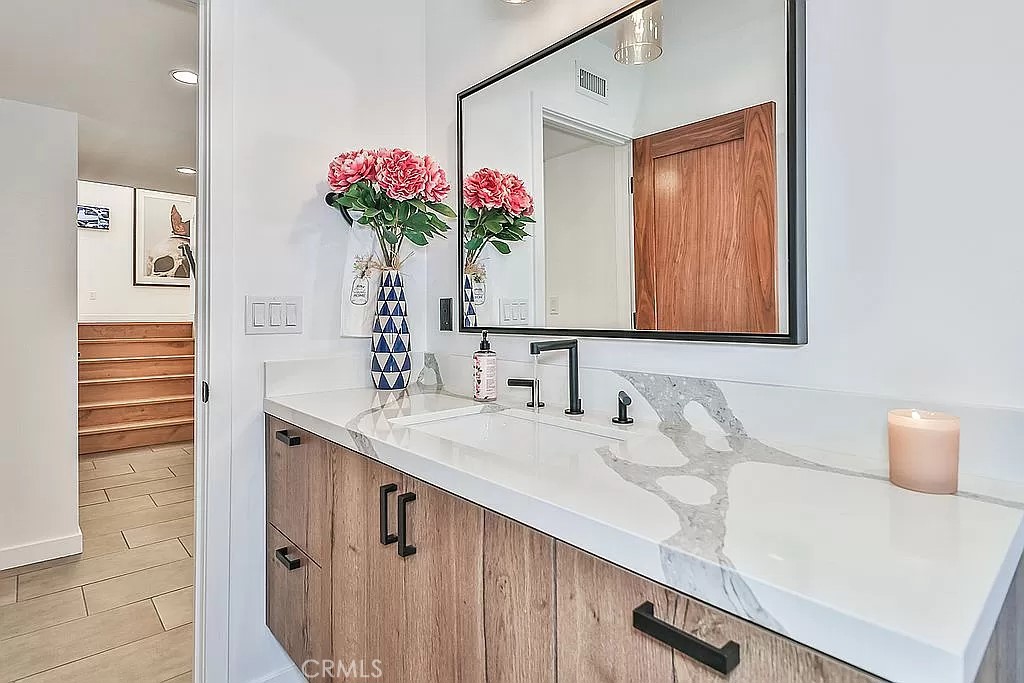 19532 Bermuda Street Porter Ranch, CA 91326 - Photo 52 of 74 a bathroom with a sink vanity and a mirror