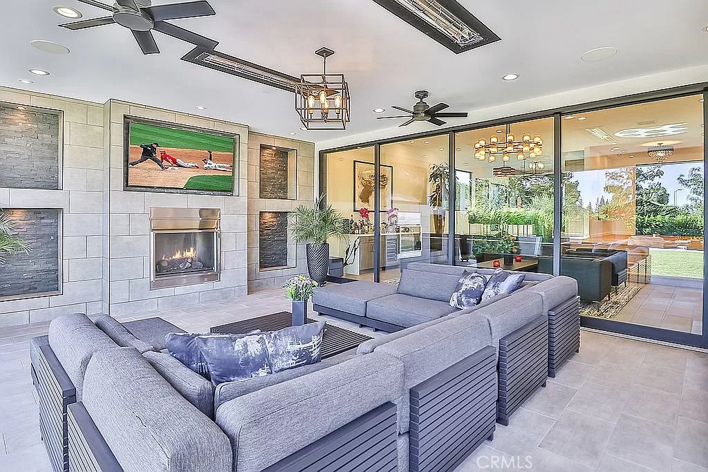19532 Bermuda Street Porter Ranch, CA 91326 - Photo 57 of 74 a living room with furniture large windows and a fireplace