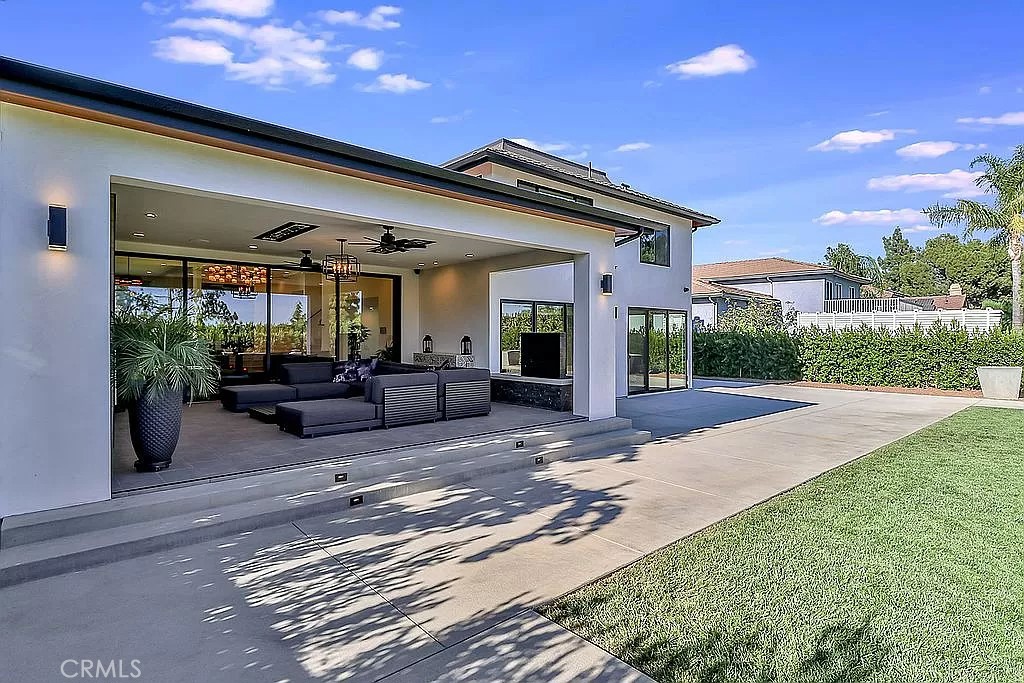 19532 Bermuda Street Porter Ranch, CA 91326 - Photo 63 of 74 a view of a patio with couches and table and chairs with wooden fence