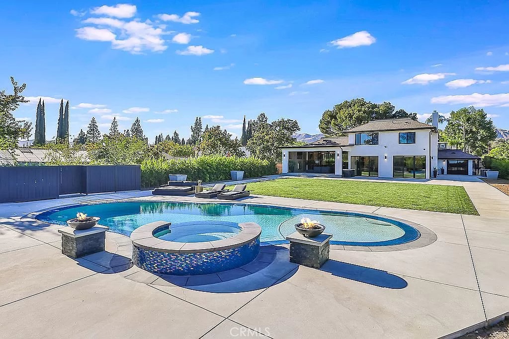 19532 Bermuda Street Porter Ranch, CA 91326 - Photo 73 of 74 a view of a house with swimming pool and yard