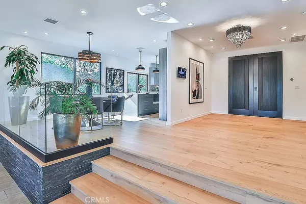 a kitchen with stainless steel appliances granite countertop a sink a stove and a refrigerator
