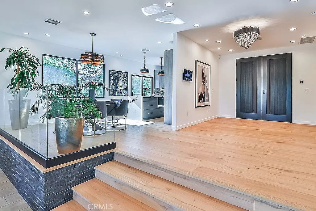 19532 Bermuda Street Porter Ranch, CA 91326 - Photo 9 of 74 a living room with kitchen island furniture and a chandelier
