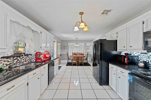 a kitchen with stainless steel appliances granite countertop a sink counter space cabinets and a counter top space