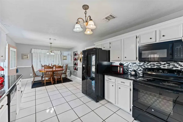 a kitchen with stainless steel appliances a stove refrigerator sink and microwave