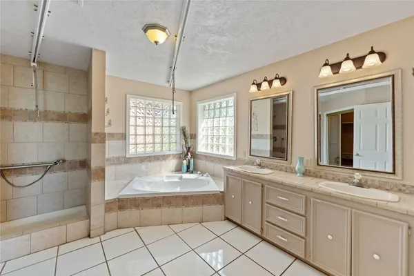 a spacious bathroom with a sink mirror and shower