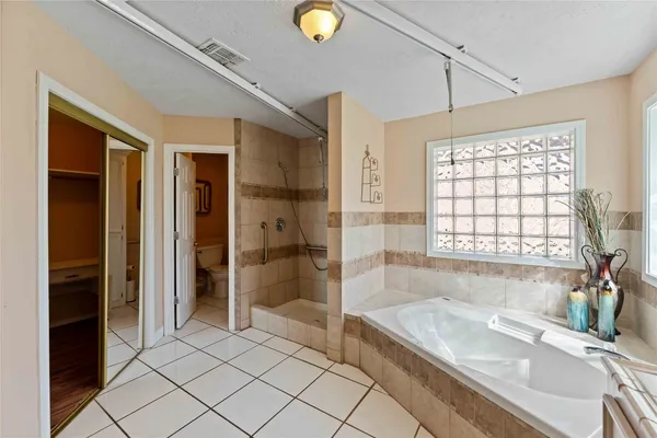a bathroom with a tub and a sink shower