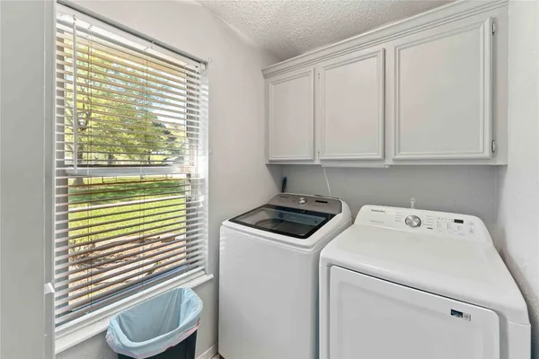 a view of storage and utility room with washer and dryer