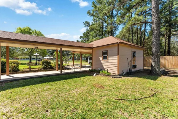 a view of a house with backyard and sitting area