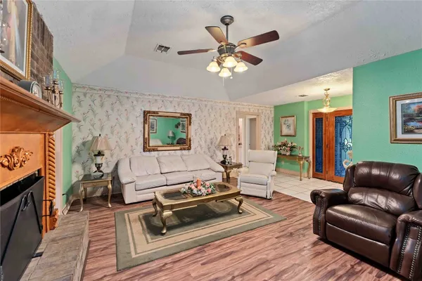 a living room with furniture a fireplace and a flat screen tv