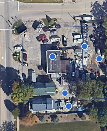 a front view of a house with garden and parking