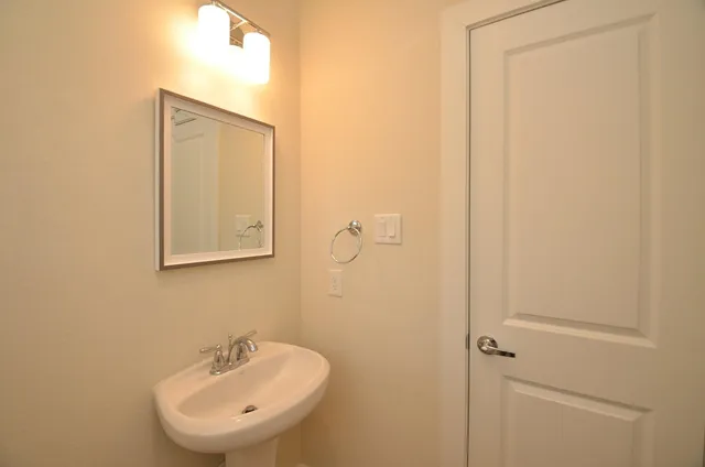 a bathroom with a sink a mirror and a toilet
