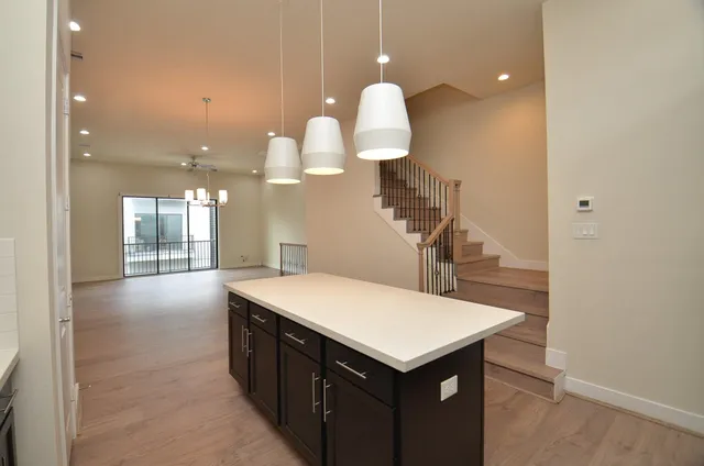 a kitchen with a sink cabinets and wooden floor