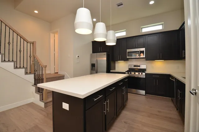 a kitchen with a sink and a refrigerator