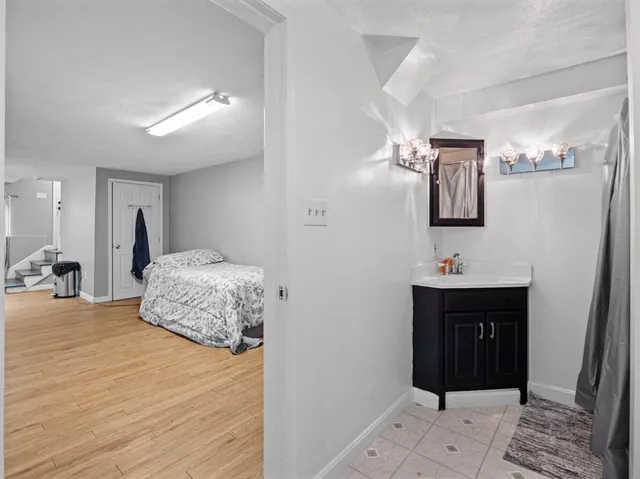 a bathroom with a sink vanity mirror and toilet
