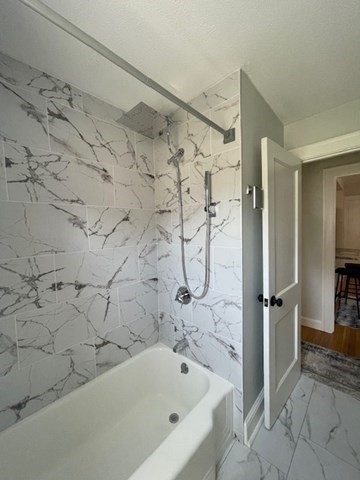 9 Common Street, Unit 1 Quincy, MA 02169 - Photo 13 of 16 a bathroom with a bathtub