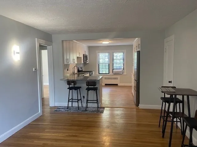 a view of a dining room with furniture and chandelier