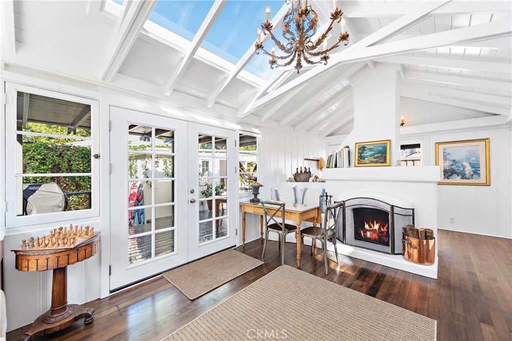 31521 Summit Road Laguna Beach, CA 92651 - Photo 1 of 21 Living room with charming wood burning fireplace. Windows, French doors and retractable skylight bring natural light and ocean breezes inside.