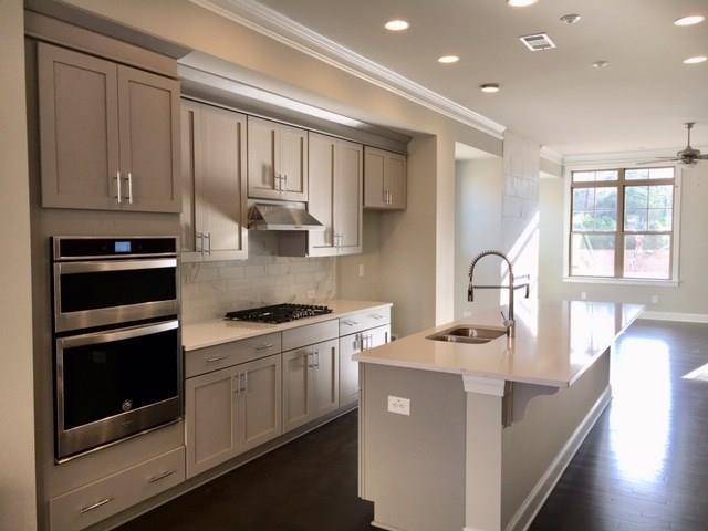 2322 Medlock Lane, Unit 40 Decatur, GA 30033 - Photo 1 of 1 a kitchen with stainless steel appliances granite countertop a stove a sink and a microwave