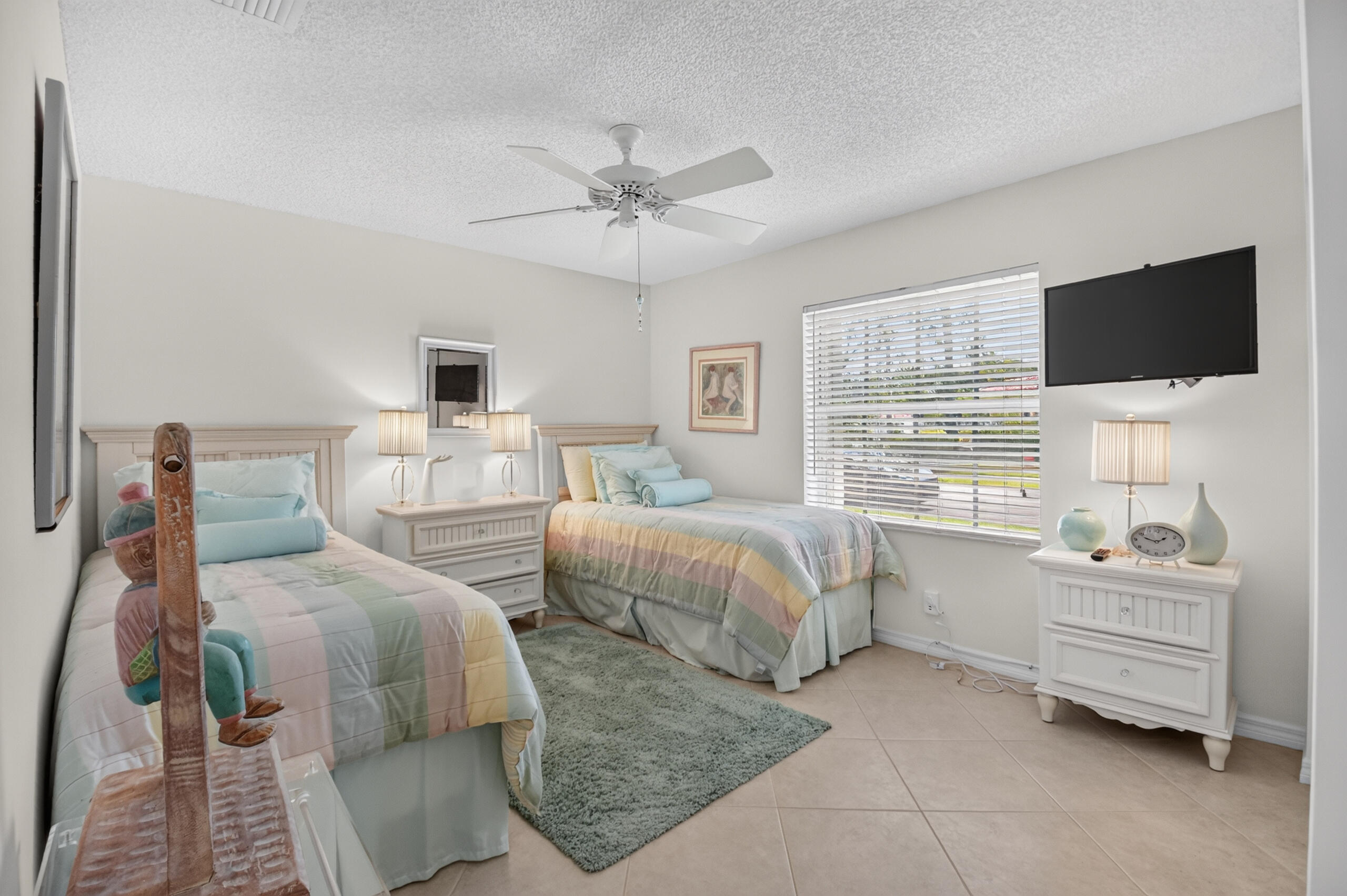 15340 Floral Club Road Delray Beach, FL 33484 - Photo 32 of 42 a bedroom with two beds and a flat screen tv