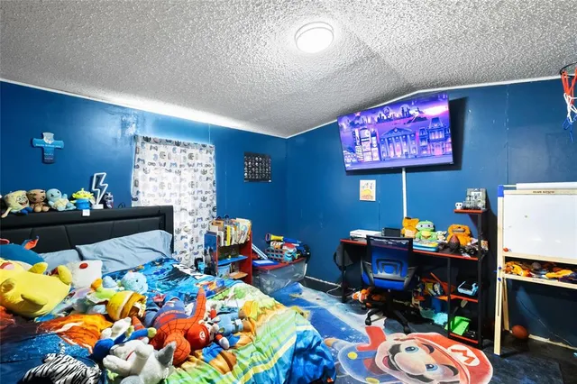 a bedroom with furniture and a floor to ceiling window