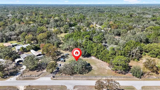 a view of a lake with a bench and chairs