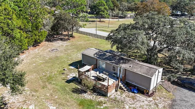 a view of a patio with table and chairs with wooden fence and plants