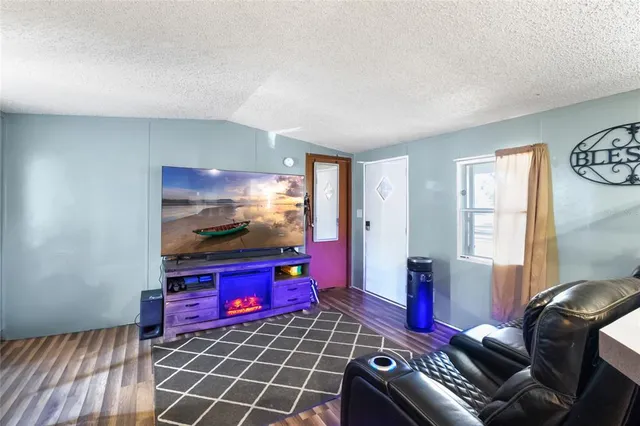 a living room with furniture a dining table and a window