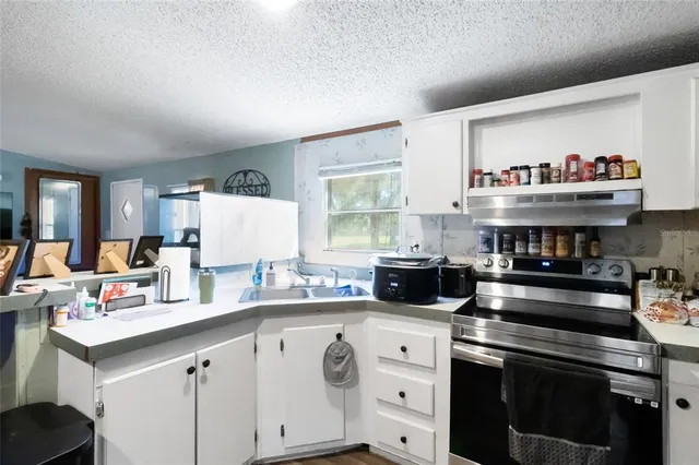 a kitchen with a stove and a refrigerator