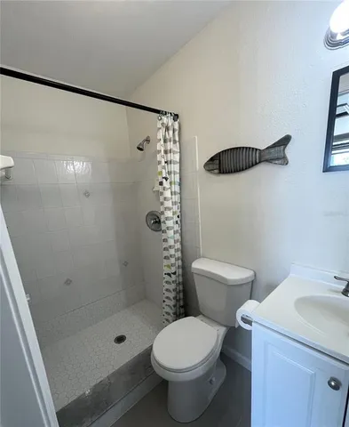 a bathroom with a toilet a sink and a mirror