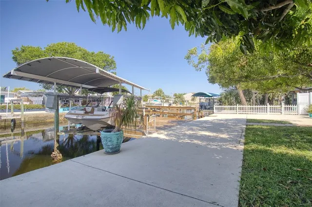 a view of backyard with swimming pool and green space