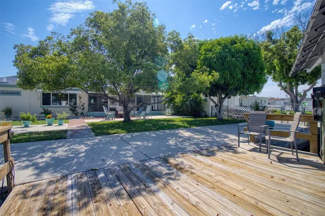 a view of a patio with couches and a table and chairs with garden view