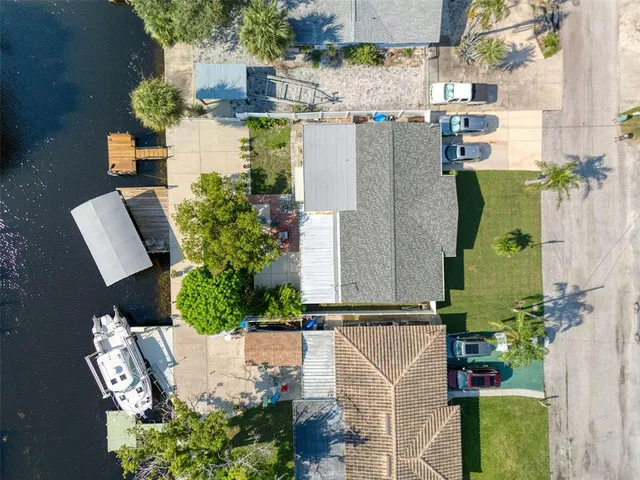 an aerial view of a houses with a swimming pool
