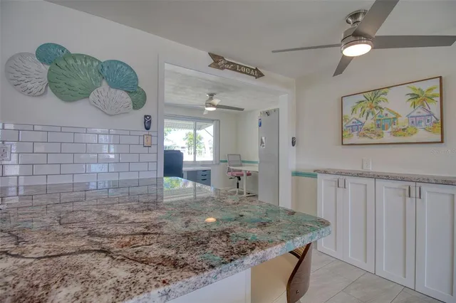 a kitchen with sink and cabinets