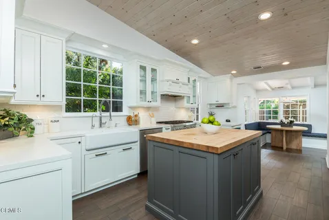 a kitchen with a sink cabinets and wooden floor